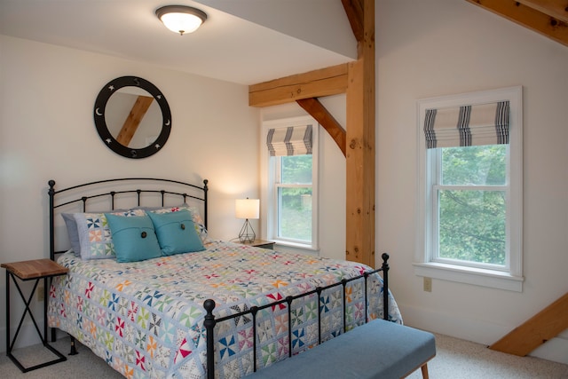 bedroom with vaulted ceiling with beams and carpet