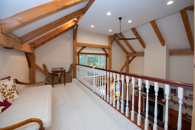 interior space with carpet floors and vaulted ceiling with beams