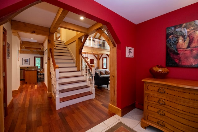 foyer entrance featuring light hardwood / wood-style flooring and beam ceiling