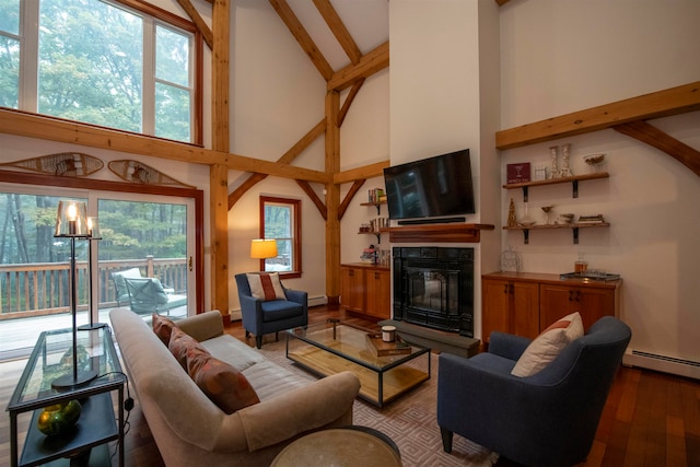 living room with an inviting chandelier, plenty of natural light, high vaulted ceiling, and hardwood / wood-style flooring