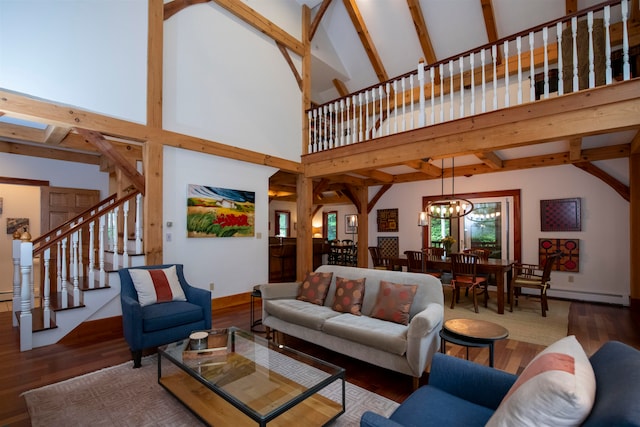 living room with high vaulted ceiling, a wealth of natural light, beam ceiling, and hardwood / wood-style floors