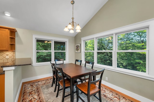 dining area featuring lofted ceiling and a notable chandelier