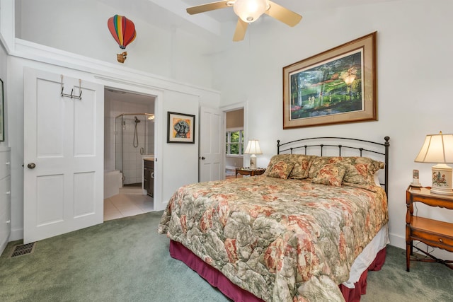 carpeted bedroom with connected bathroom and ceiling fan