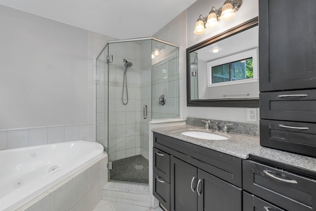 bathroom with plus walk in shower, tile patterned flooring, and vanity