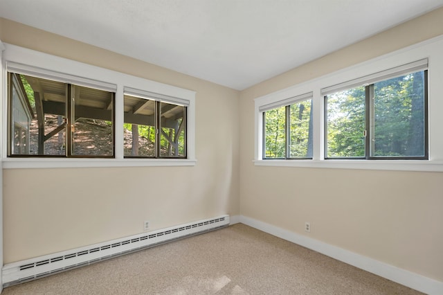 carpeted empty room with a baseboard heating unit