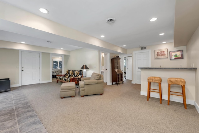 carpeted living room with bar