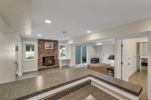 living room featuring a brick fireplace