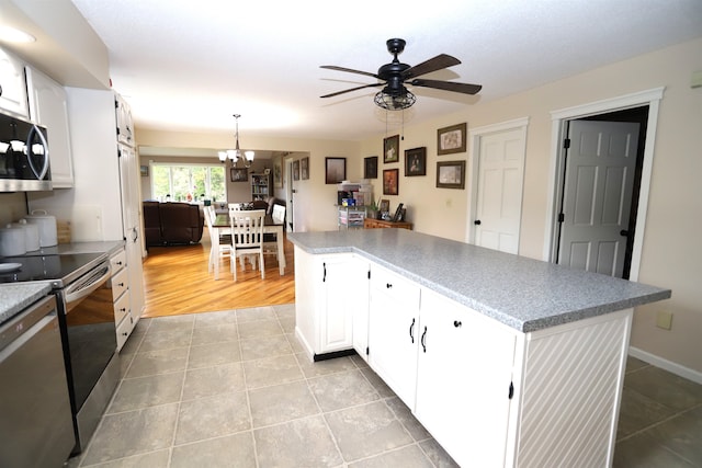 kitchen featuring ceiling fan with notable chandelier, light hardwood / wood-style floors, white cabinetry, and stainless steel appliances