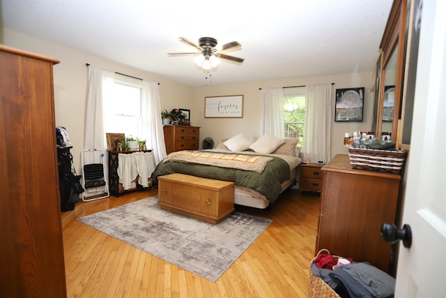 bedroom with ceiling fan and light hardwood / wood-style flooring