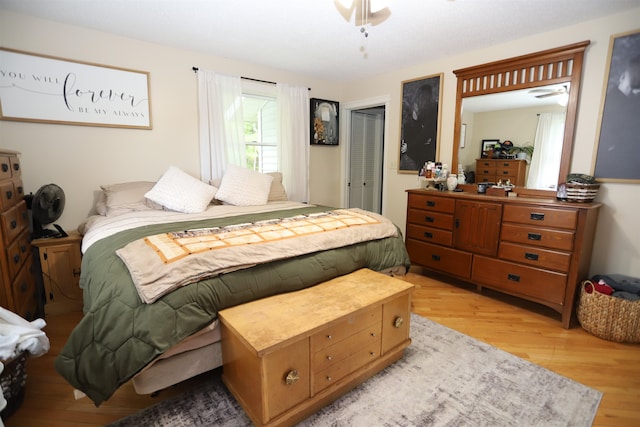 bedroom with light hardwood / wood-style flooring and a closet