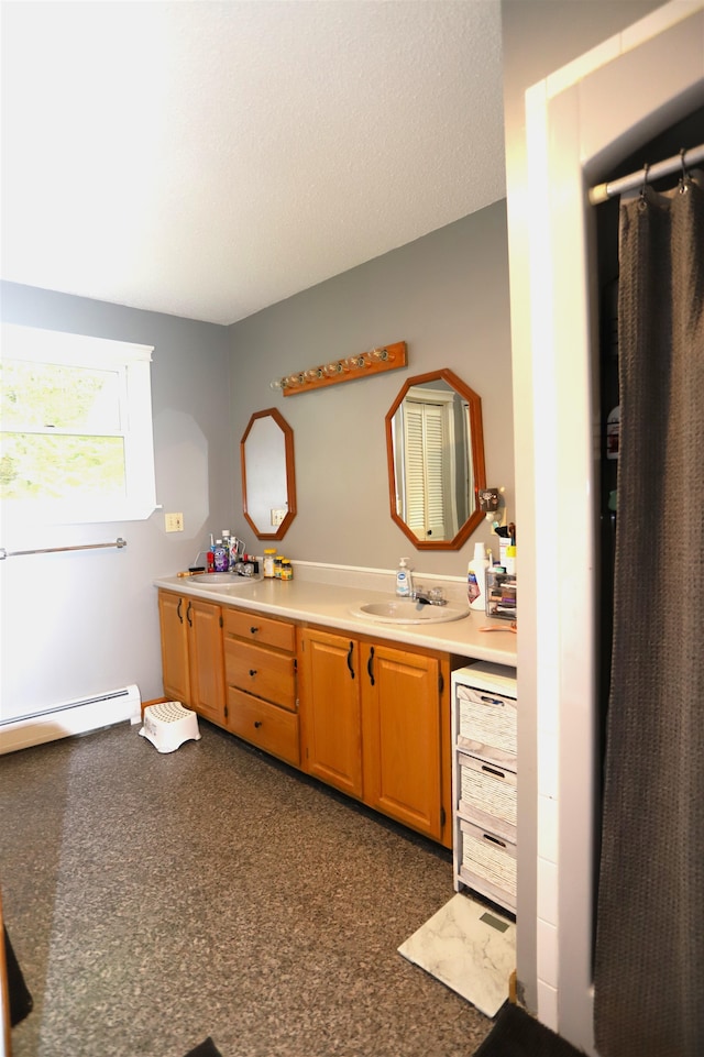 kitchen featuring baseboard heating and sink