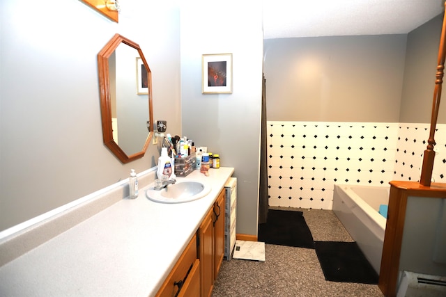 bathroom featuring a baseboard radiator, a washtub, and vanity