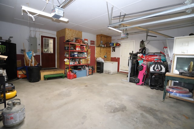 garage featuring electric panel and a garage door opener