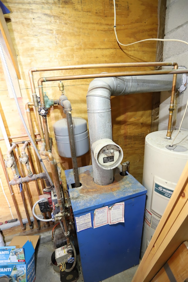 utility room featuring water heater