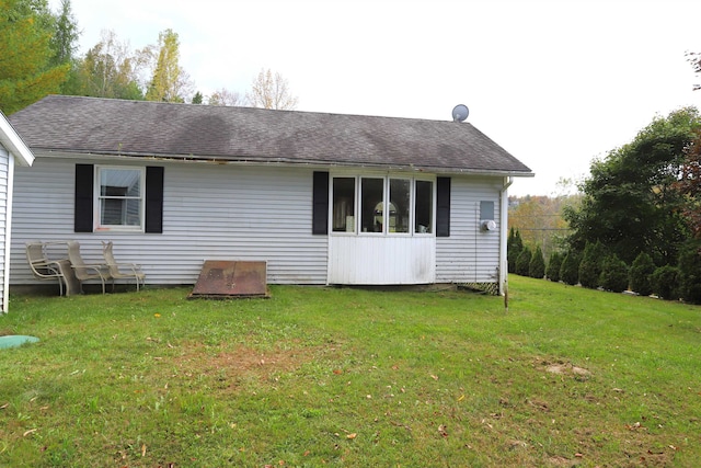 back of property featuring a lawn