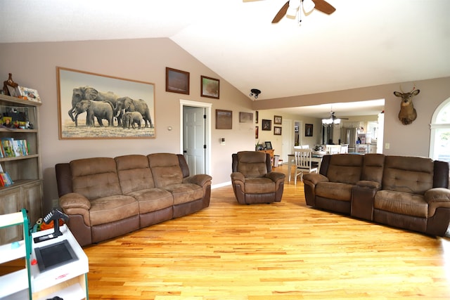 living room with ceiling fan, lofted ceiling, and light hardwood / wood-style floors