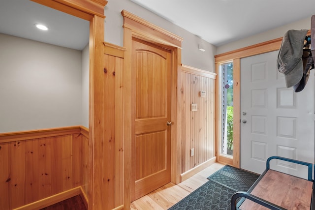 entryway featuring wood walls and hardwood / wood-style floors