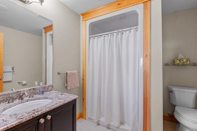 bathroom with vanity, toilet, and tile patterned floors