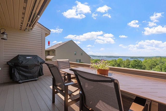 deck featuring a water view and a grill