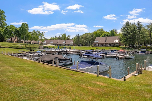 dock area featuring a lawn and a water view