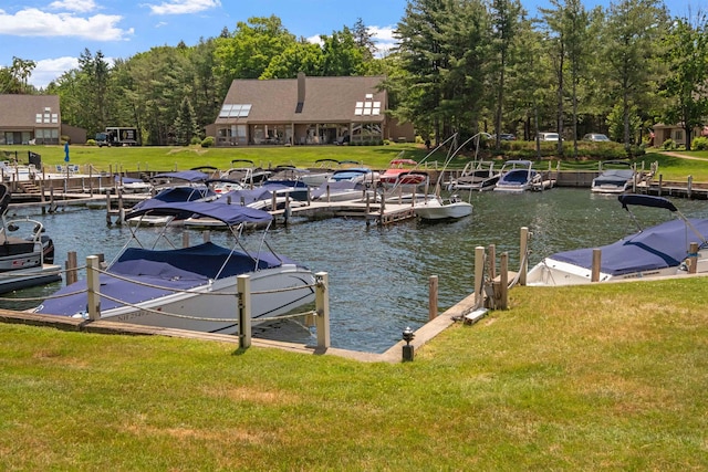 dock area featuring a lawn and a water view