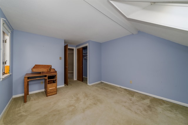 bonus room featuring light carpet and lofted ceiling with beams