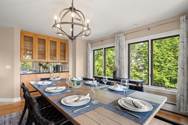 dining area featuring a notable chandelier and light hardwood / wood-style flooring