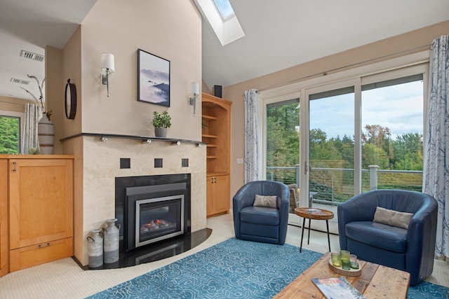 living room featuring light hardwood / wood-style floors, a healthy amount of sunlight, and lofted ceiling