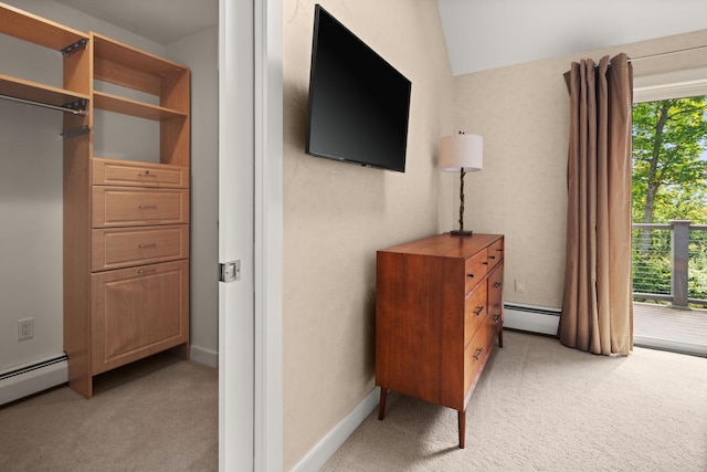 carpeted bedroom featuring a baseboard radiator and vaulted ceiling