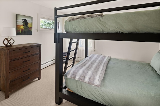 carpeted bedroom featuring baseboard heating