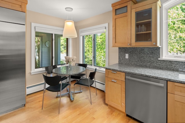 kitchen featuring light wood-type flooring, a baseboard radiator, stainless steel appliances, decorative backsplash, and decorative light fixtures