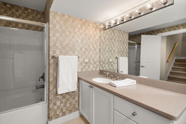 bathroom featuring vanity and enclosed tub / shower combo