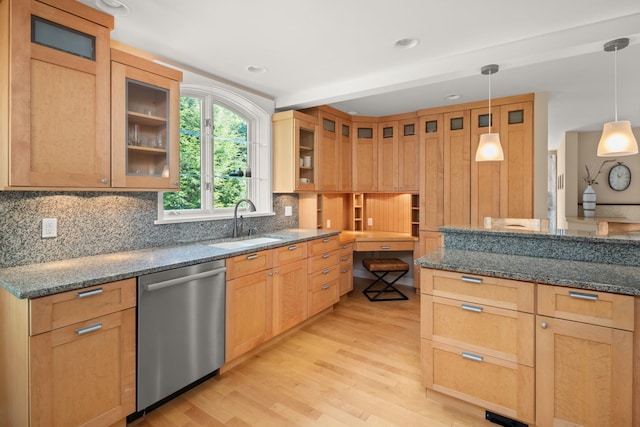 kitchen with dishwasher, light hardwood / wood-style floors, dark stone countertops, and decorative light fixtures