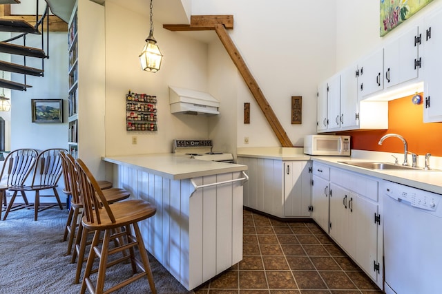27 Lawrence Hill Rd Unit 5, Weston, VT 05161 - kitchen with white appliances, custom exhaust hood, a sink, white cabinets, and a towering ceiling