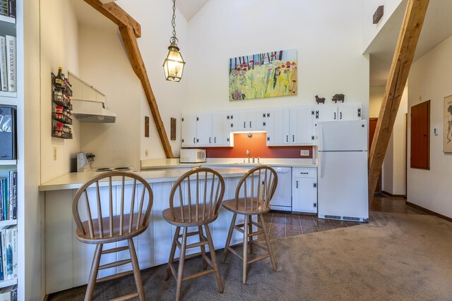 27 Lawrence Hill Rd Unit 5, Weston, VT 05161 - kitchen with white appliances, light countertops, a sink, white cabinetry, and high vaulted ceiling