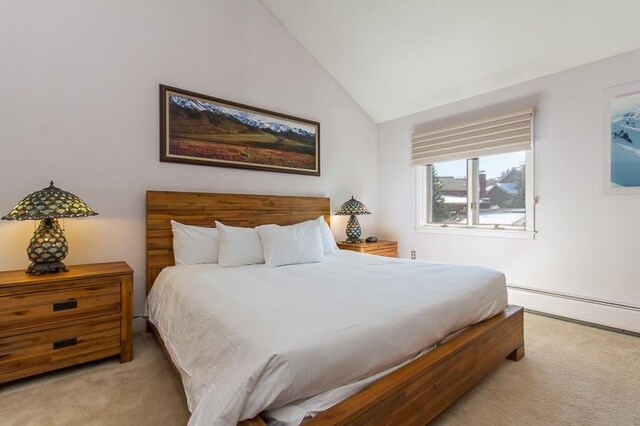 carpeted bedroom featuring lofted ceiling