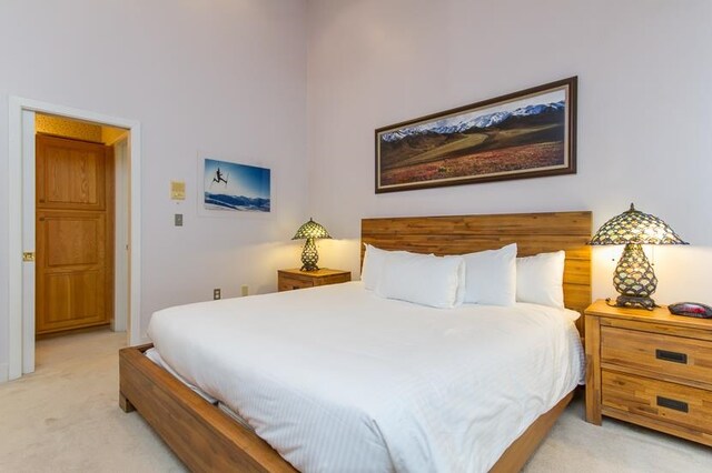 bedroom featuring light colored carpet