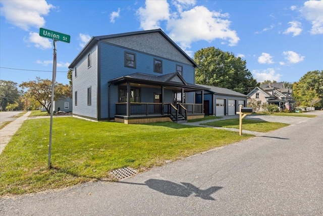 view of front of home with a garage, a front yard, and covered porch