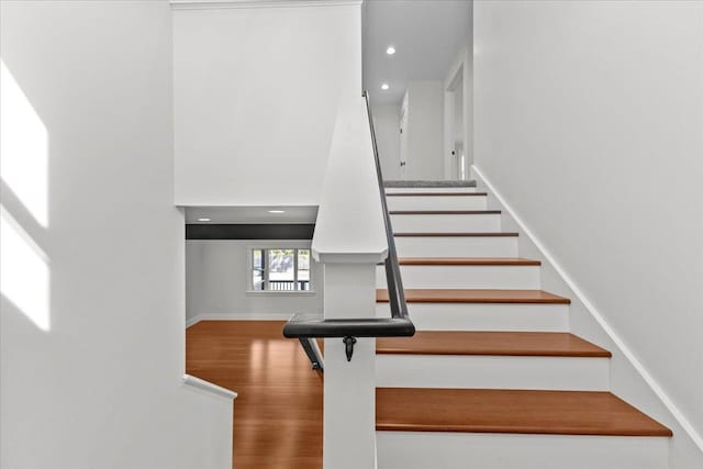 staircase with wood-type flooring