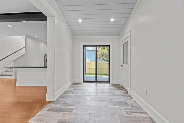 entryway featuring baseboards, recessed lighting, and stairs
