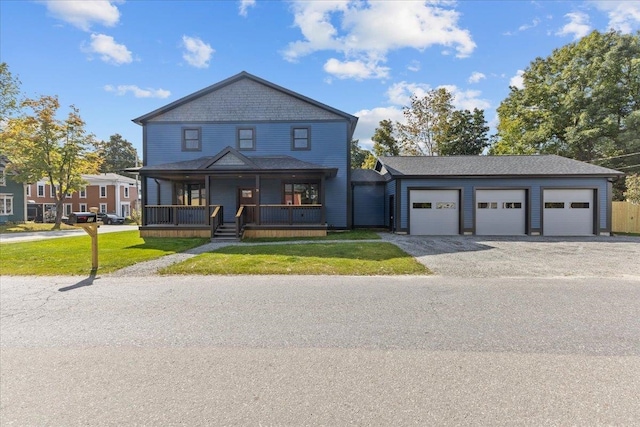 view of front of property with a front lawn, a garage, and covered porch