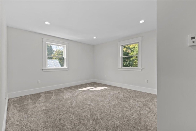 spare room with carpet floors and plenty of natural light