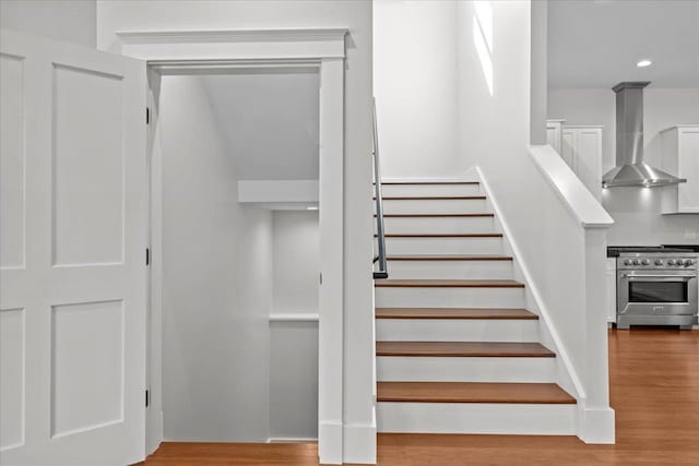 stairway featuring wood-type flooring