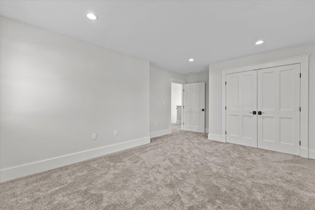 unfurnished bedroom with a closet, baseboards, carpet flooring, and recessed lighting