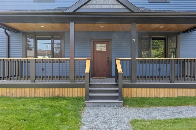 view of exterior entry with a porch