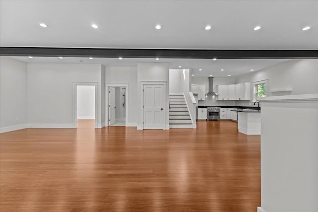 unfurnished living room featuring light hardwood / wood-style floors and sink