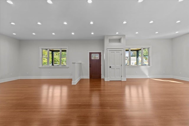 unfurnished living room with a healthy amount of sunlight and light hardwood / wood-style flooring