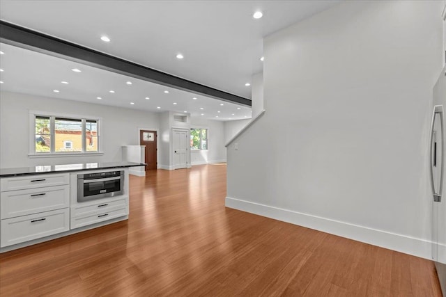 kitchen featuring white cabinets, light hardwood / wood-style flooring, stainless steel appliances, and a healthy amount of sunlight