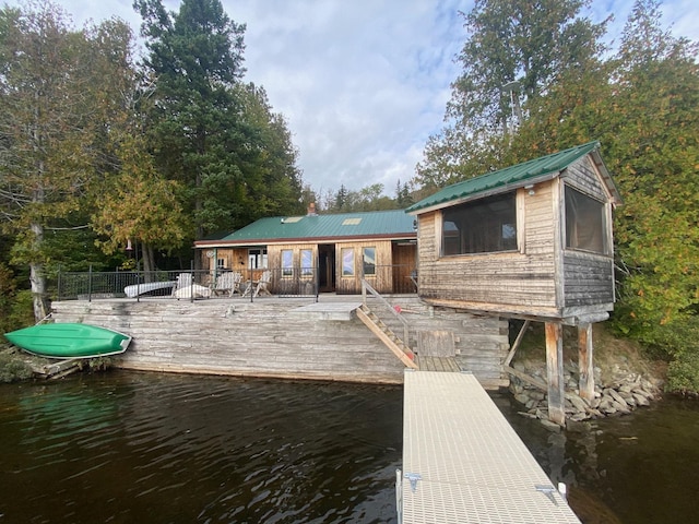 rear view of property featuring a water view