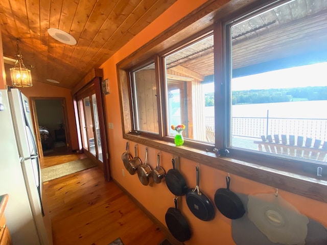 corridor featuring lofted ceiling, hardwood / wood-style floors, and wood ceiling